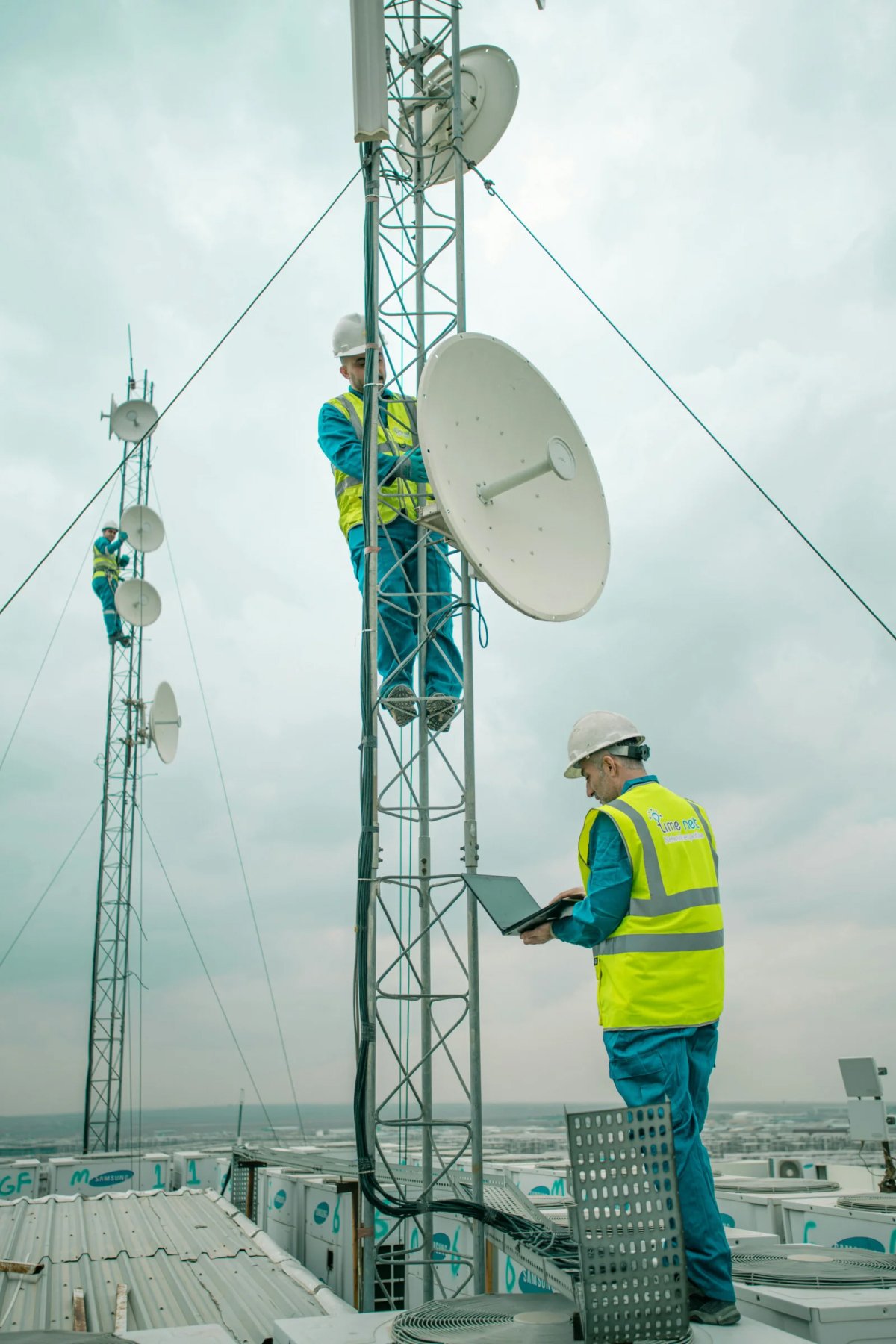 Engineers working on microwave tower