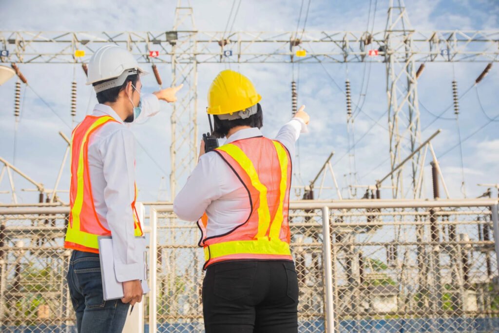 Engineer and worker lookin electrical grid
