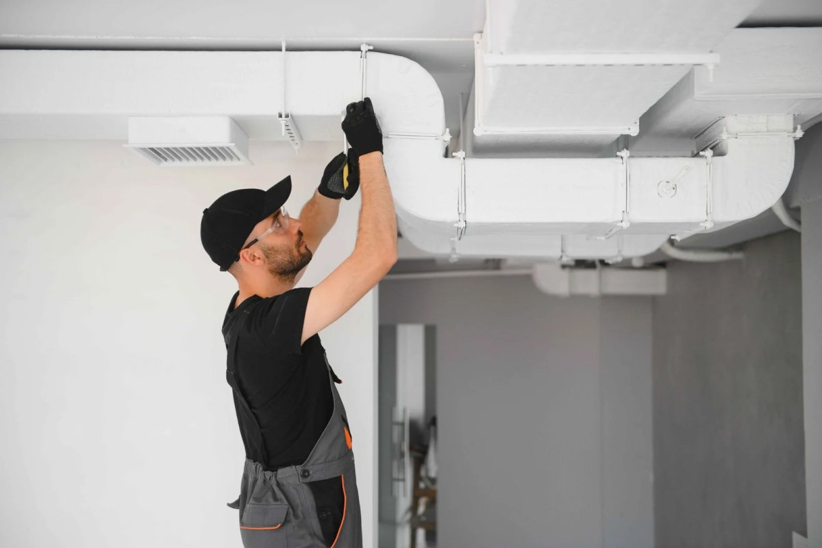 HVAC services worker install ducted pipe system for ventilation and air conditioning in house