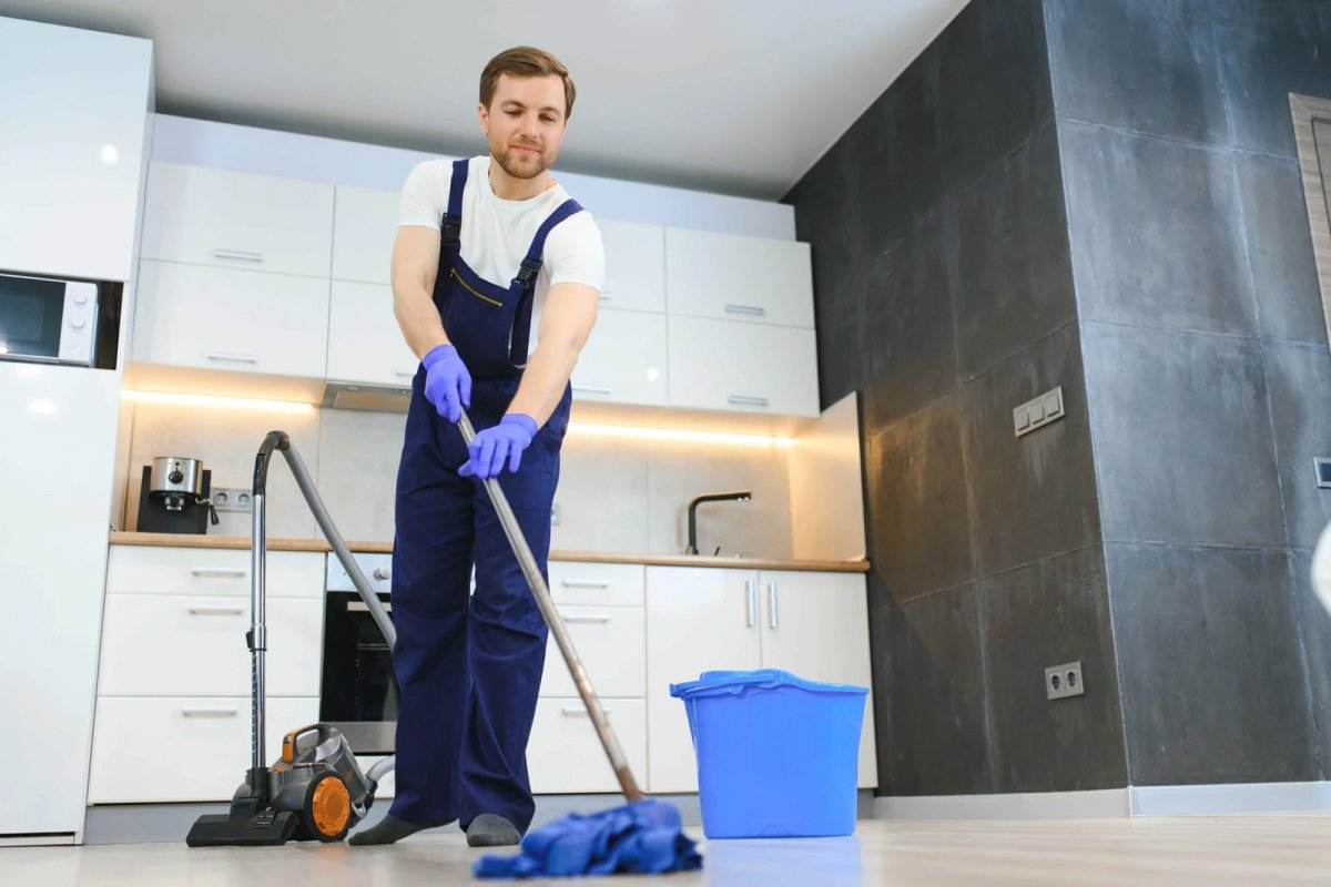 professional cleaner washing floor wiping dust from furniture